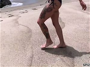 Anna Bell Peaks smashing a enormous pink cigar on the beach